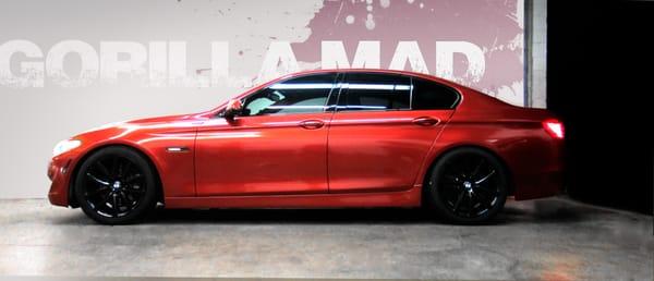 2011 BMW 535i full vinyl wrap in Gloss Red Pearl with blacked out trim. By Gorilla Mad Film Wraps