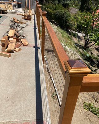 Fence railing and deck made from red wood.