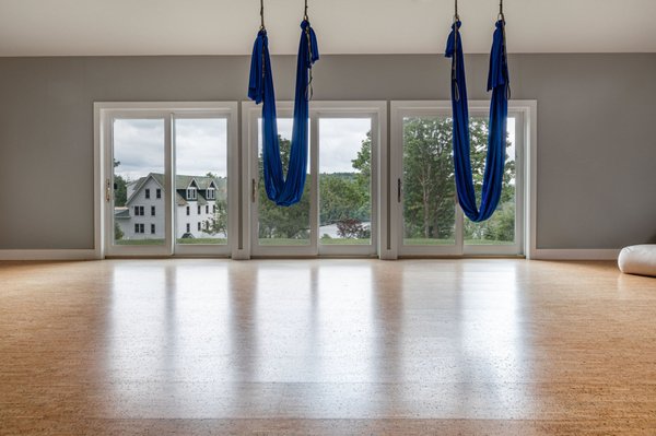 This is our yoga space where we offer a variety of different yoga classes. Here are the aerial silks we use for aerial yoga.