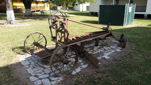 Farm implement behind gas station