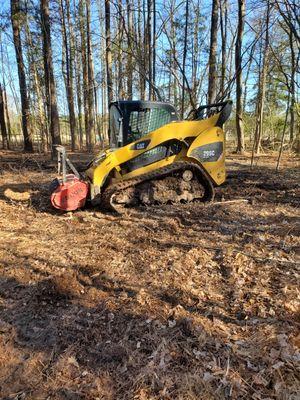 Skidsteer with forestry mulcher. (Mulches any trees/brush up to 6" diameter)