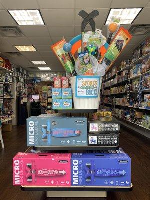 Seasonal front table, curated for summer. Come in for all your shoes, outdoor fun, and toy needs!