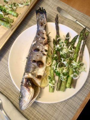 Whole Bronzino stuffed with lemon and herbs and roasted asparagus