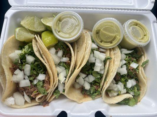 Barbacoa Tacos with cilantro and onion with avocado salsa