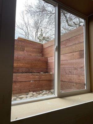 Beautiful large egress window with terraced timber well