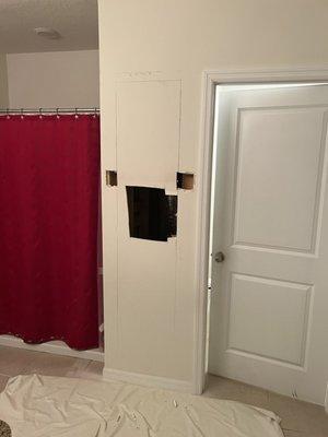 Before we opened up the wall and started to build the custom bathroom storage area