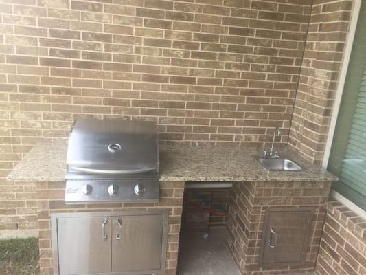 Outdoor kitchen-26"grill with double door, space for fridge, and sink with single door.