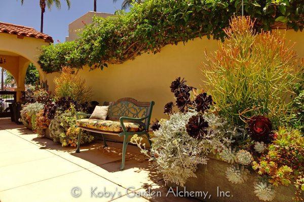 This unused driveway area was transformed into a pleasant seating area among large planter gardens.