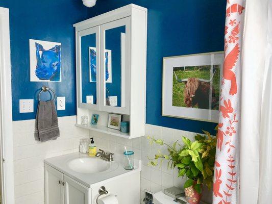 This small blue bathroom was truly a budget renovation, showing how it does not cost a lot of money to have a lovely space.