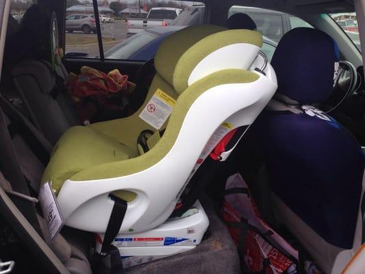 Testing out a car seat. They brought it to the car!