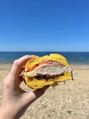 Turkey, Swiss, bacon, tomato, Russian on an egg bagel.