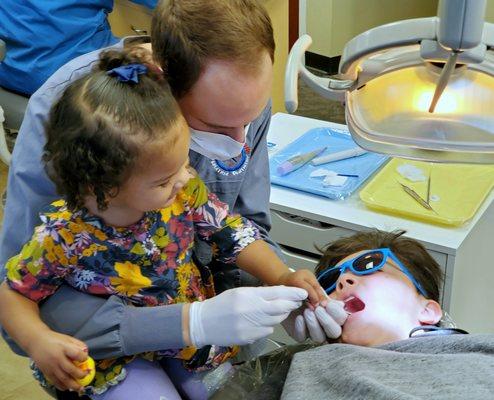 Doctor-in-Training Amira helps Dr. Slaven clean her brother's teeth.