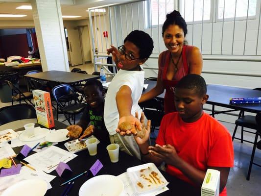 Youth campers having fun with healthy foods at a summer camp nutrition class.