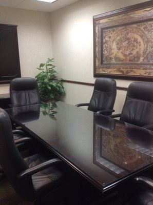 Medium Conference Room, able to accommodate up to 8 people.