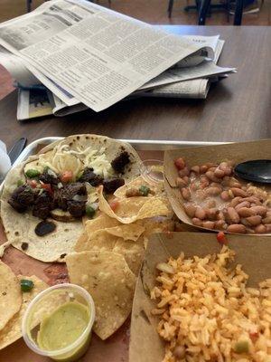 Brisket and potato taco with rice and beans