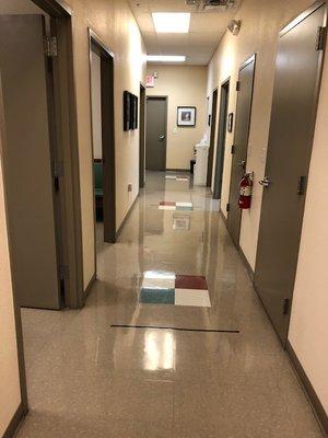 Hallway with water fountain and a restroom leading to the patient care rooms.