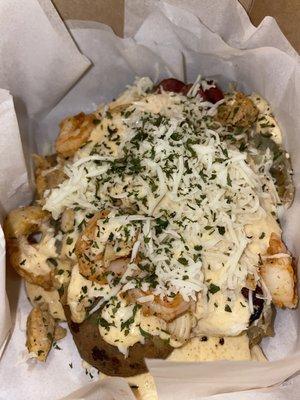 Spicy New Orleans Potato includes chicken, shrimp, beef sausage, spicy creamy alfredo sauce, and mozzarella cheese