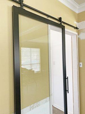 Barn door with exposed hardware