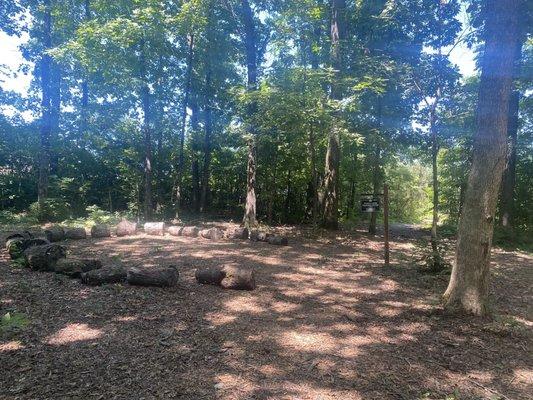 Clearing in the woods and also at a fork in the road.  We chose to do the right path, down a small hill.