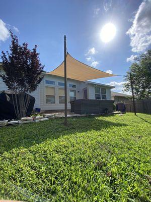 Our new sail shade! We got the bamboo color shade with recycled drill stem pipe poles.