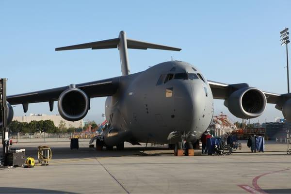 C-17 parked in front of the 787