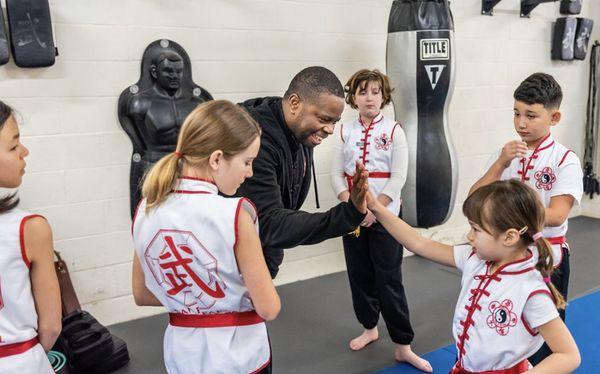 Nothing like a high five to start off a great class. Picture from 2018.