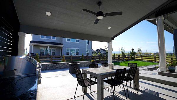 New build backyard with patio cover, outdoor kitchen, turf, fire pit, seating wall, concrete steppers and patio