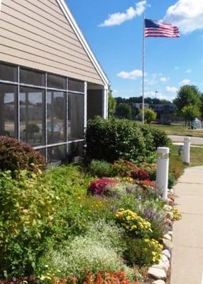 Beautiful gardens in front and well tended raised vegetable beds in back