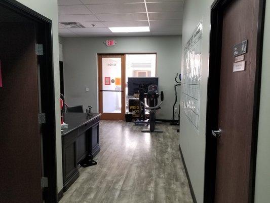 Hallway from the entrance leading the the treatment room (right) and the bathroom directly across (left).