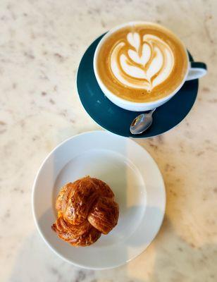 croissant in a knot and latte