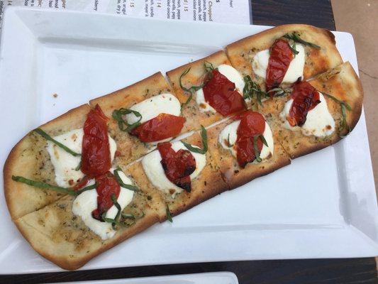 Artichoke Caper Flatbread with roasted tomatoes.