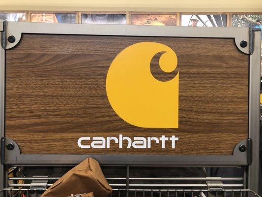 Impressive inventory of Carhartt clothing and boots.