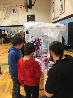 Drew refills the Paint-A-Pult ammo at Aspen Creek K-8's STEAM Expo Night 2020.