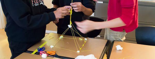 The marshmallow challenge explores innovative thinking and team communication.