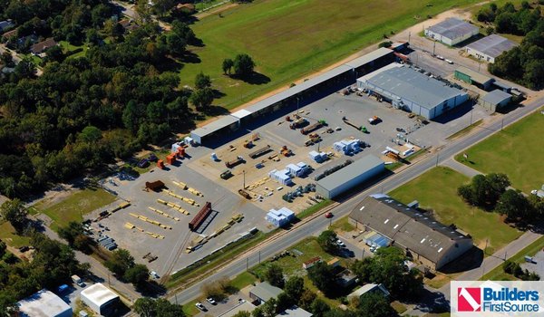 Building materials supplier Builders FirstSource's forklift is moving wood roof trusses.