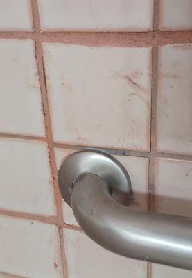 Uneven grout lines, mismatched grout color