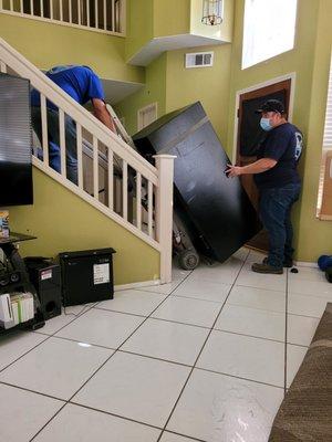 Very tight fit up the staircase but with the proper equipment they were able to get the job done