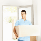 Moving in apartment - Happy guy carrying a cardboard box