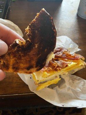 Egg, bacon and cheese on a burnt everything bagel