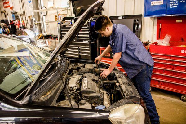 Here's a photo of one of our team members working on a vehicle! We strive to always provide efficient and effective services.