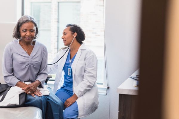 A female physician providing a check up.