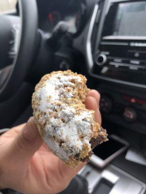 Chocolate peanut donut with confectionary sugar