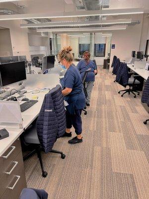 Professional janitors cleaning local office in NYC.