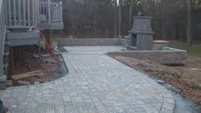 custom patio with outdoor fireplace installation