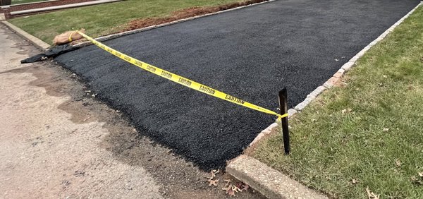 Uneven paving where the driveway meets the street. It's also way too high. It's breaking and falling apart now.