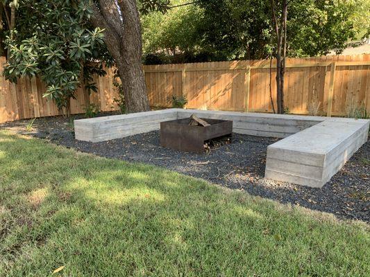 Board form concrete bench with custom steel planter.