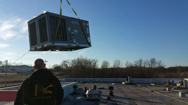 Crane moving rooftop unit