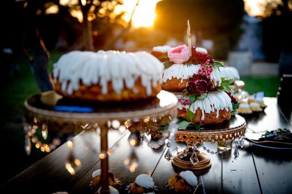 Dessert table, multiple cakes and bundtinis.