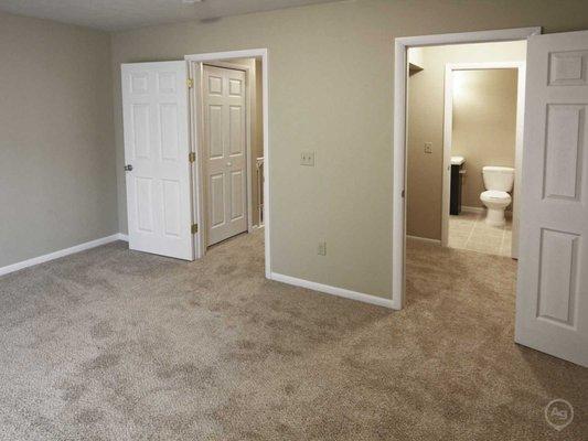 Spacious walk- thru closet between master bathroom and master bedroom.