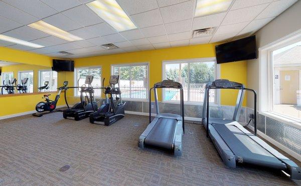 Cardio equipment in onsite fitness center at Bloomfield Townhomes in Ketnwood, MI